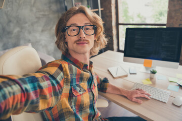 Photo portrait man wearing glasses taking selfie working on computer coding remotely at home
