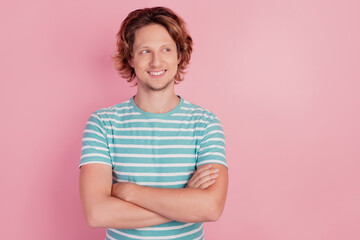 Photo of cheerful smart man crossed arms look empty space wear casual blue striped t-shirt on pink background
