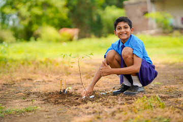 Indian school child doing tree plantation.
