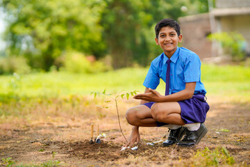 Indian school child doing tree plantation.