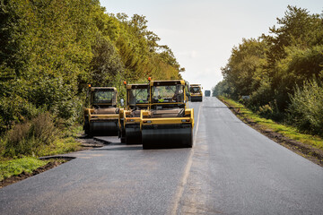 Fototapeta na wymiar road rollers lay new asphalt