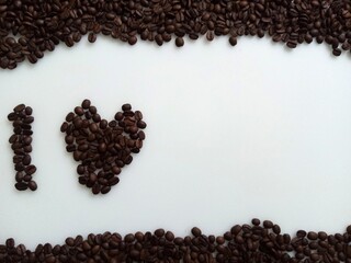 Coffee heart on White background top view with copy space for text. Minimal style 