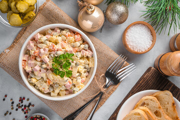 Traditional olivier salad on a festive background. Top view.