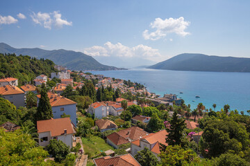 Fototapeta na wymiar View of the city of Herceg Novi, blue sea and tiled red roofs in Montenegro, Europe
