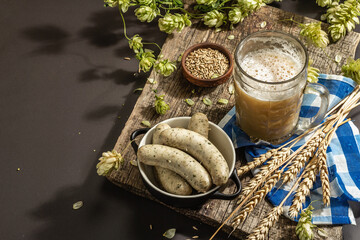 Oktoberfest set. Unfiltered beer, weisswurst, spikelets of grain, hop