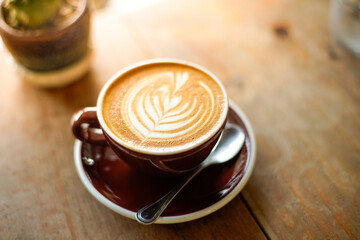 Cup of coffee beside window show mood and tone of shade and shadow with nice milk art.