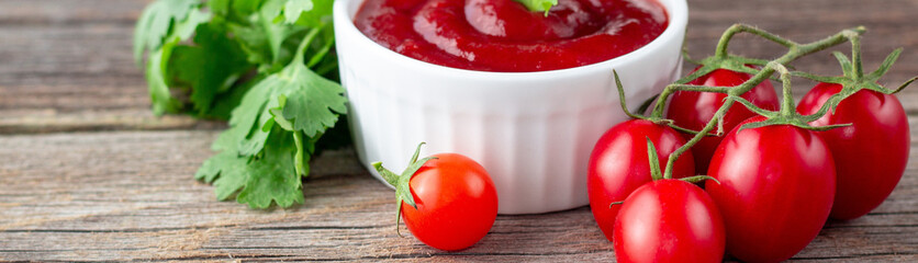 banner of White bowl of tomato sauce with parsley and tomato. Ketchup on natural wooden background
