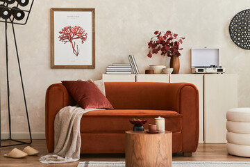 Stylish interior of modern living room with retro design sofa, mock up poster frame, pouf and...