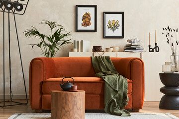 Stylish interior of modern living room with two mock up poster frames, retro design sofa, plants,...