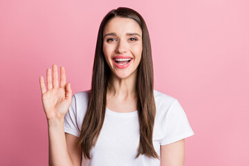 Portrait of attractive cheerful girl waving you hi hello web meeting isolated over pink pastel color background © deagreez