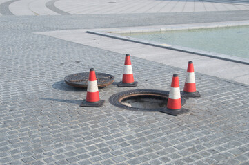 Open manhole with metal cover. Open sewer manhole.
