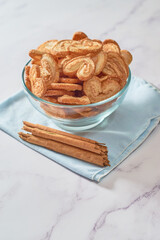 Palmier puff pastry cookies or elephant ears in a bowl of caramelized and crunchy pastry.