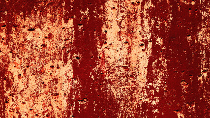 Abstract defective concrete wall with light and red peeling paint