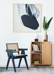 Modern composition of living room interior with design black chair, wooden bookcase, tropical leaf...