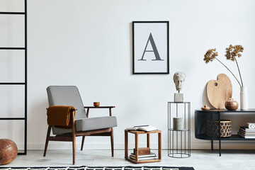 Stylish scandinavian composition of living room with design armchair, black mock up poster frame,...