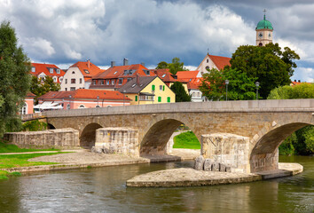 Obraz premium Regensburg. Embankment and old stone bridge over the Danube river.