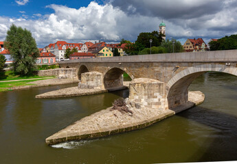 Fototapeta premium Regensburg. Embankment and old stone bridge over the Danube river.