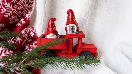Christmas composition with Scandinavian gnomes and a red car