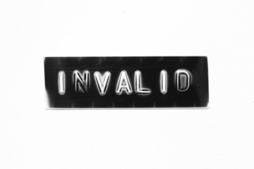 Black color banner that have embossed letter with word invalid on white paper background