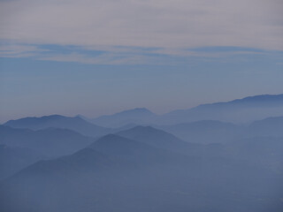 Beautiful view of the mountains covered with fog.