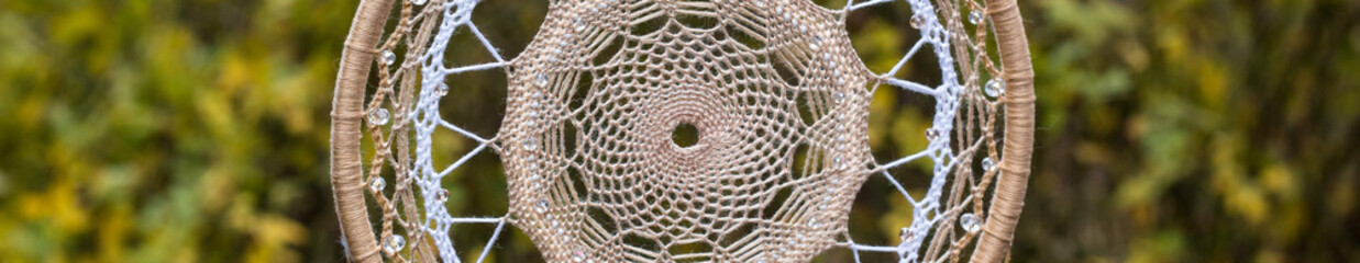 banner of Handmade dream catcher with feathers threads and beads rope hanging