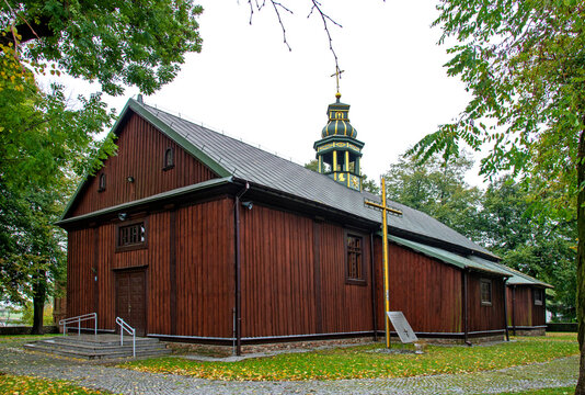 Built in 1839, a brick neo-Gothic belfry and a wooden church under the invocation of St. James the Apostle in Góra in Masovia in Poland. Photo: general view of the temple and close-up of architectural
