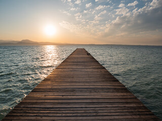 Fototapeta na wymiar Lake Garda Jetty at Sunrise called Il Pontile di Sirmione in Summer