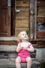 Fototapeta premium Little girl, blonde, in a pink summer suit