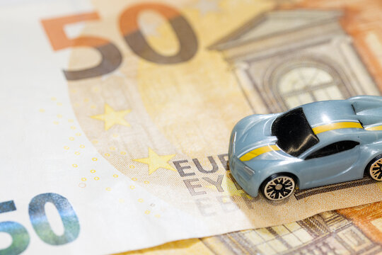 Toy cars with money. Euro cash with mini car. Concept image for rent car and automotive market.