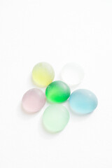 Flower made from glass stones on white paper