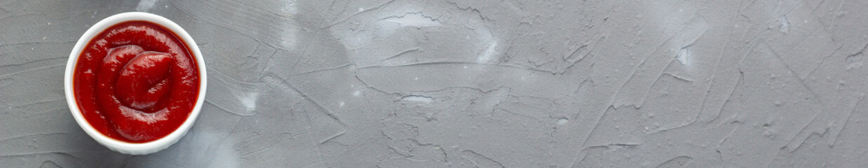 banner of ketchup classic sauce on gray stone background.
