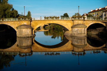 Fototapeta premium Historic bridge ,moyen pont over the Seille river in Metz France with mirror reflection on the water