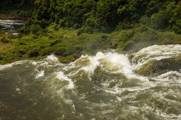 Water motion background. Closeup view of the Iguazú falls in Misiones Argentina. The beautiful falling white water in the tropical forest.