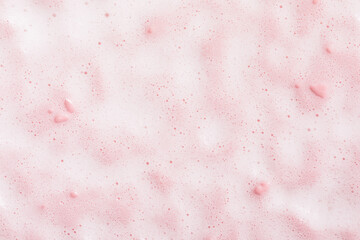 Texture soapy foam of cosmetic cleanser on pink surface