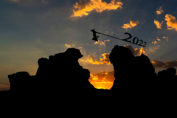 2021, Silhouette of man jumping over mountain, Concept to start a new day and a new year