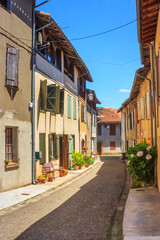 Summer city landscape - view of a medieval street in a provincial French town, in the historical province Gascony, the region of Occitanie of southwestern France