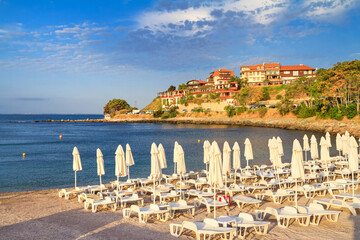Coastal landscape - view of the beach with umbrellas in the Old Town of Nessebar, on the Black Sea coast of Bulgaria