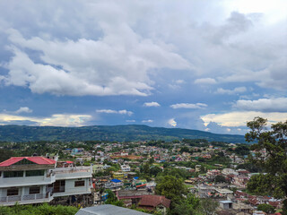 Fototapeta na wymiar city urbanization view with mountain range at background at morning from flat angle