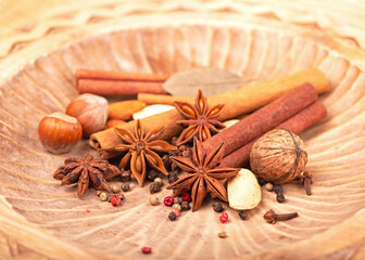 Traditional Christmas spices - Star anise with cinnamon and cloves on dark rustic wooden background