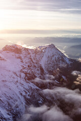 Aerial View of Canadian Rocky Mountains with snow on top during Fall Season Sunset. Nature Landscape located near Chilliwack, East of Vancouver, BC, Canada.