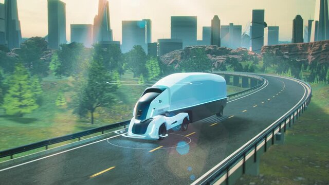 Futuristic autonomous electric truck on highway drives on the road with sensors scanning surroundings. 