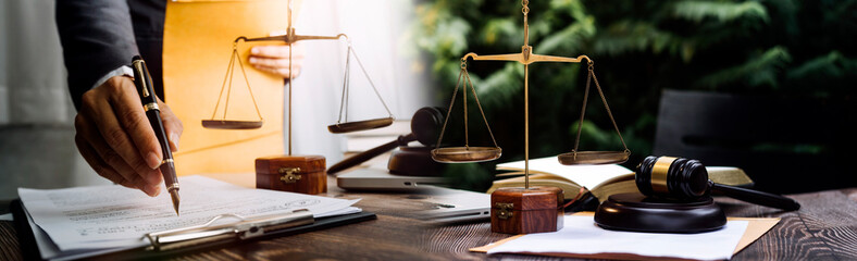 Justice and law concept.Male judge in a courtroom with the gavel, working with, computer and...