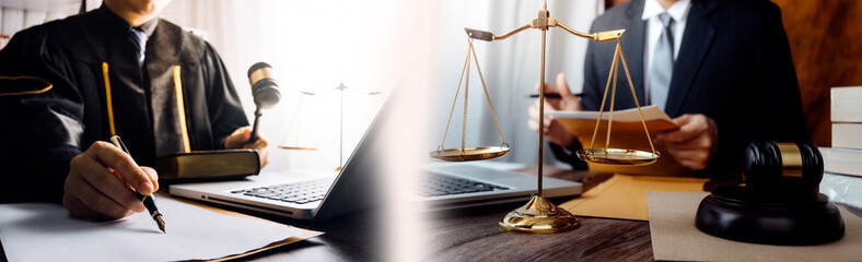 Justice and law concept.Male judge in a courtroom with the gavel, working with, computer and docking keyboard, eyeglasses, on table in morning light