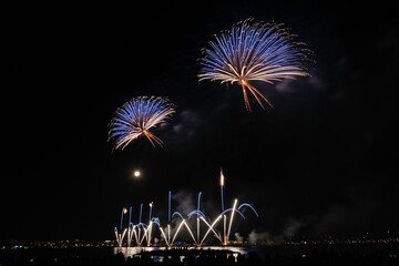 Scenic fireworks at night in the harbor of Cannes, France