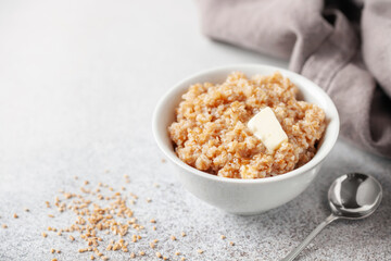 Wheat porridge with butter in a ceramic bowl. Healthy breakfast