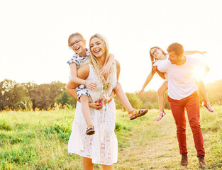 Fototapeta premium child family outdoor mother woman father girl happy happiness lifestyle having fun bonding piggyback