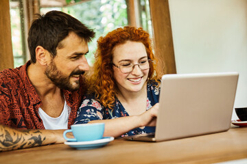 fun woman man couple cafe  happy together smiling  love using communication coffee shop laptop computer