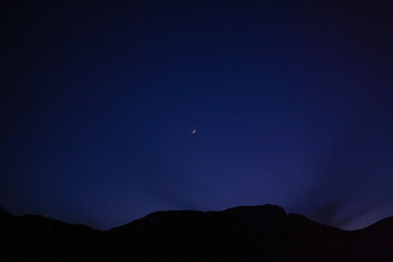 The quiet night sky and mountains at dawn.

