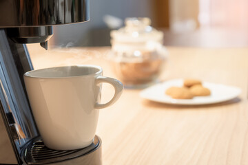 Fototapeta na wymiar Aromatic hot coffee from a freshly brewed coffee machine ,Hot coffee in White ceramic coffee mug 