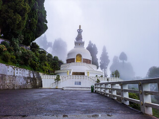 buddhist shanti stupa covered with cloud at morning from different angle